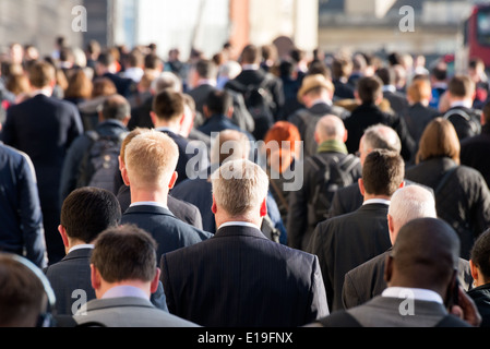 Commuters crossing crowded London Bridge on the way home from work, UK Stock Photo