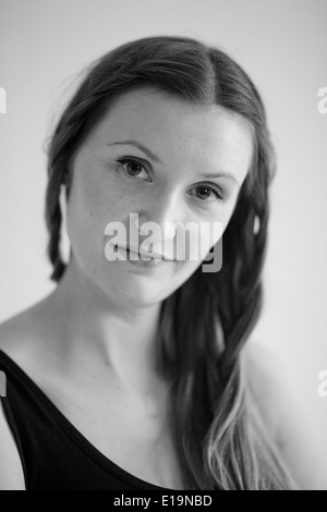 Closeup black and white studio portrait of relaxed looking attractive woman wearing dark blouse Stock Photo