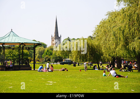 Bandstand in Bancroft Gardens with the Holy Trinity Church spire to the rear, Stratford-Upon-Avon, England. Stock Photo