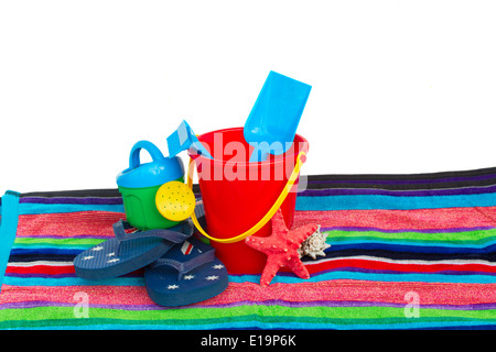 beach toys with flip flops and starfish on towel Stock Photo