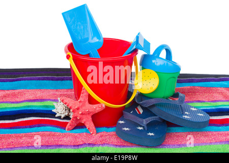 beach toys with flip flops and starfish on towel Stock Photo