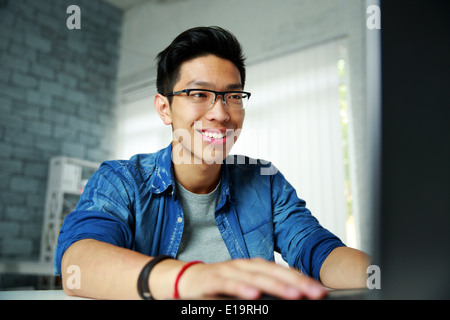 Happy young asian man working at office Stock Photo