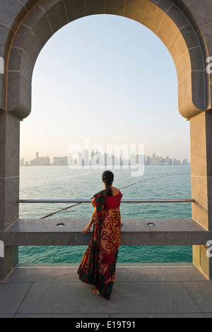 Doha. Qatar. Vistitor looking across Bay of Doha from the Museum of Islamic Art.