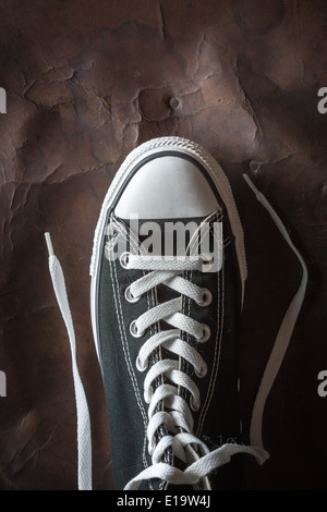 one Sneaker on old Leather Stock Photo - Alamy