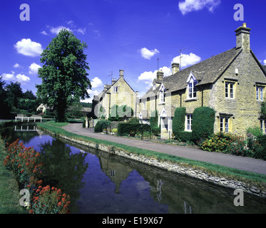 The Idyllic Cotswold village of Lower Slaughter on summers day beside the river Eye. Stock Photo