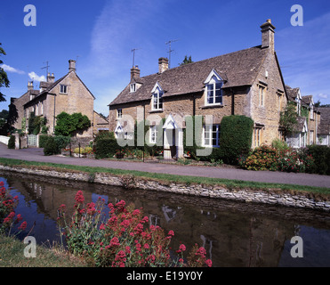 The Idyllic Cotswold village of Lower Slaughter on summers day beside the river Eye. Stock Photo