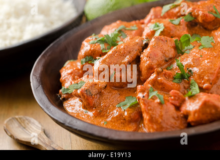 A delicious bowl of creamy butter chicken with basmati rice and cilantro. Stock Photo