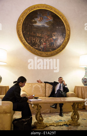 US President Barack Obama receives an update by telephone on the Affordable Care Act, at Villa Madama March 7, 2014 in Rome, Italy. At left is National Security Advisor Susan E. Rice. Stock Photo
