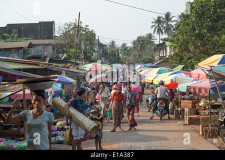 The market in Bago, Myanmar is bustling with daily activity as locals do their shopping for produce. Stock Photo