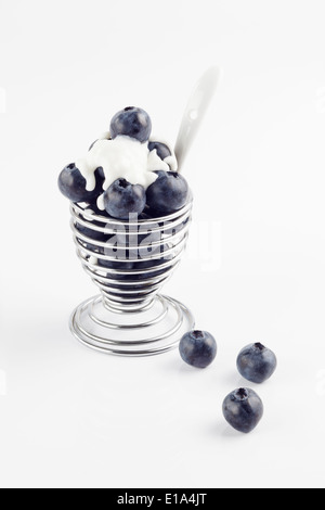 Egg Cup filled with fresh Blueberries topped with natural Yogurt Stock Photo
