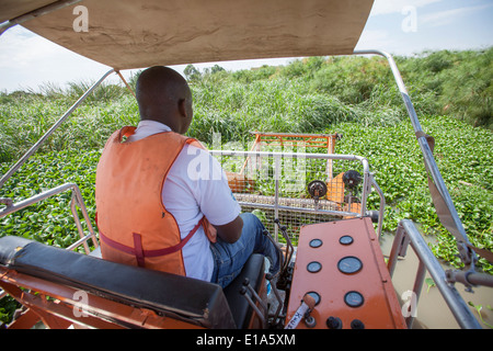 Water Hyacinth (Eichhornia Crassipes) harvester on Lake Victoria. Stock Photo