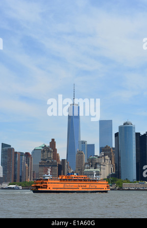 Staten Island Ferry in New York Harbor with the Lower Manhattan skyline in the background. Stock Photo