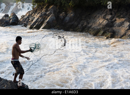 Net fishing at the Khone Phapheng Falls, Mekong River,, Champasak, Laos. Fisherman is Saimoun from Ban Takho Village, 28 years. Stock Photo