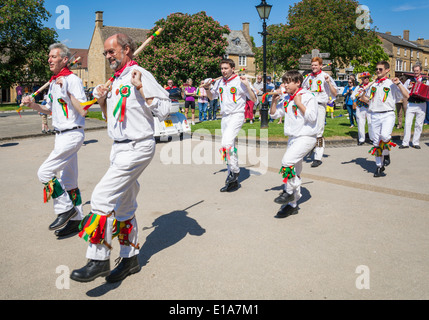 Morris Dancing by morris men in traditional costumes at a village fete in the village of Broadway The Cotswolds Worcestershire England UK GB Europe Stock Photo