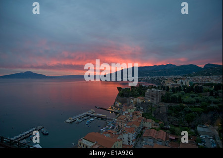 A fiery sunrise with red sky over Sorrento, the Bay of Naples and Mount Vesuvius, an active volcano, Italy Stock Photo