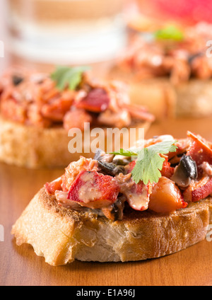Lobster with mushrooms in a creamy cheese sauce on toasted french bread baguette. Stock Photo