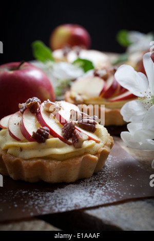 Tartlets with apple slices, cream and pecan filling Stock Photo