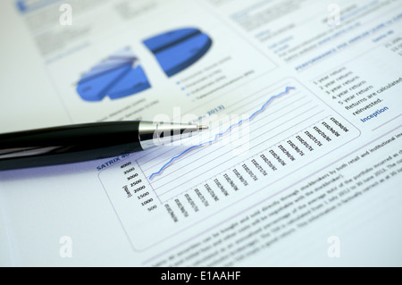 financial document with graphs and pen Stock Photo
