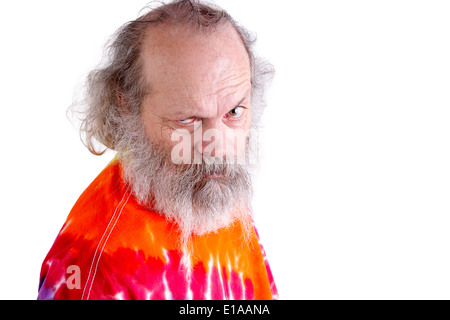 Casual long bearded and haired man with tie dye T-shirt man looking at you questioningly one eyebrow lifted Stock Photo
