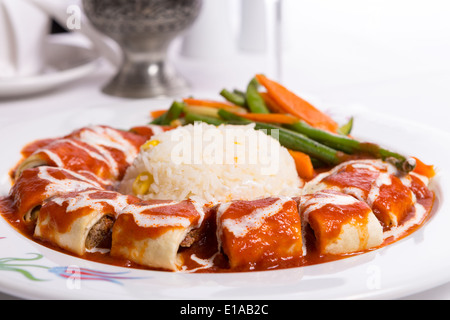 Turkish Beyti Kebap garnished with vegetables Stock Photo