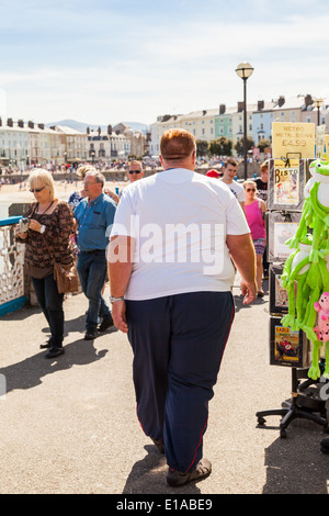 Over weight man, walking along Llandudno pier, Llandudno,North Wales, Great Britain. Stock Photo