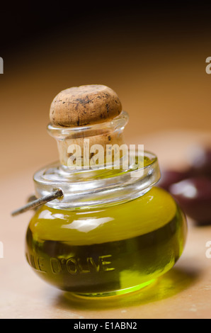 A bottle of extra virgin olive oil with olives. Stock Photo