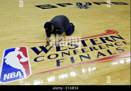 May 19, 2014 - San Antonio, TEXAS, USA - AT&T Center employee Cecilio Santibanez applies the Western Conference Finals logo to the court before Game 1 between the San Antonio Spurs and Oklahoma City Thunder Monday May 19, 2014 at the AT&T Center. (Credit Image: © San Antonio Express-News/ZUMAPRESS.com) Stock Photo