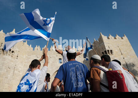 Jerusalem, Israel. 28th May, 2014. Young Israelis dancing with the Israeli national flag during the traditional flag march at the old city during 47th anniversary of Jerusalem's reunification on 28  May 2014. Israel marked its 47th Jerusalem Day  commemorating the reunification of the city following th 1967 Six-Day War by the traditional Jerusalem Day flag march around the Old City, as well as several ceremonies. Credit:  Eddie Gerald/Alamy Live News Stock Photo