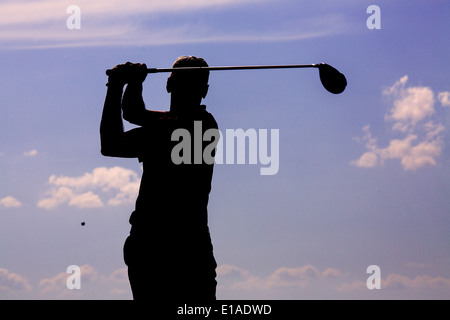 Silhouette of golf player at the end of his swing in Capitals golf club, Lithuania Stock Photo