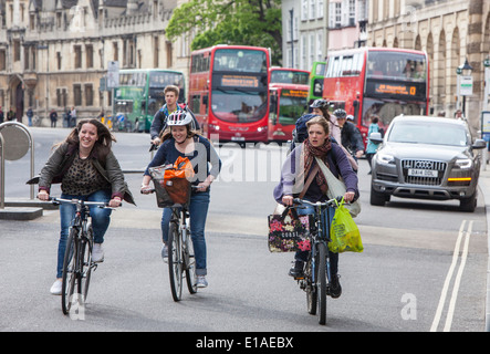 Young ladies cycling through the city of Oxford, Oxfordshire, England, UK Stock Photo