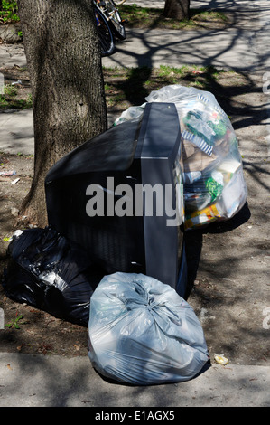 A TV thrown out with the garbage Stock Photo