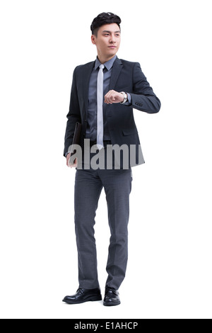 Businessman checking the time on wristwatch Stock Photo