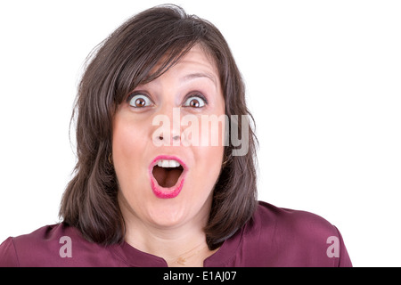 Happily amazed dark haired lady looking in to your eyes with her mouth wide open Stock Photo