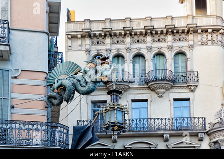 Chinese Dragon Sculpture on the Walls of a House Decorated with Umbrellas,  Bruno Quadras Building, Las Ramblas, Barcelona Stock Photo