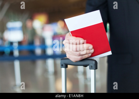 close up of passport and ticket in hand in airport Stock Photo