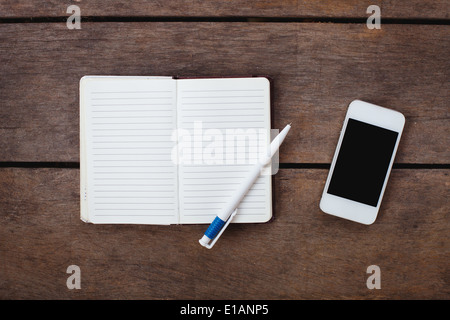 smartphone and notepad on the desk Stock Photo