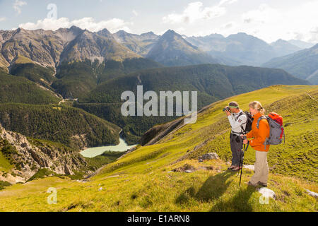 Hikers descending from Mt Murter into the Spöl Valley, Val dal Spöl, Swiss National Park, Graubünden, Switzerland Stock Photo