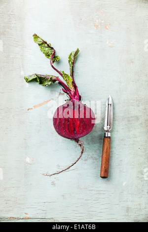 Ripe beetroot with leaves on textured background Stock Photo