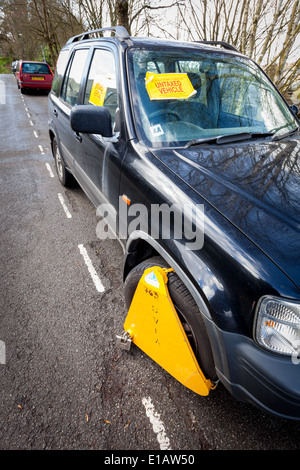 BATH, UK - MARCH 22 2014 : A car which has been clamped by the DVLA because it is untaxed. Stock Photo