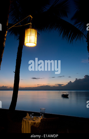 A table set for a romantic dinner on a beach on Le Morne Brabant Peninsula Stock Photo
