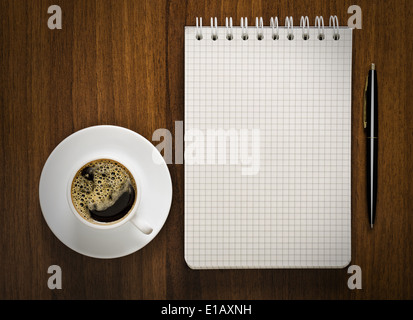 notebook with pen and cup of coffee on your desktop Stock Photo