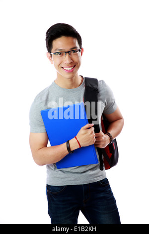 Young student with backpack and notebook standing over white background Stock Photo