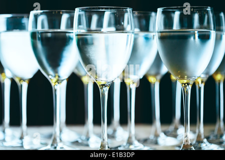 Row of water glasses. Pure drinking water. Selective focus. Stock Photo