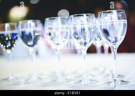 Row of water glasses. Pure drinking water. Selective focus, abstract background, concept of catering Stock Photo