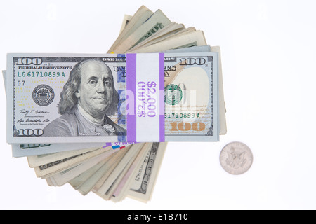 Stacked bundles of American 100 dollar bills in bank wrapping forming a spiral viewed from above isolated on white with a single Stock Photo