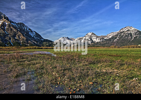 Panoramic and scenic view of rugged Waterton mountains, against a blue sky. Stock Photo