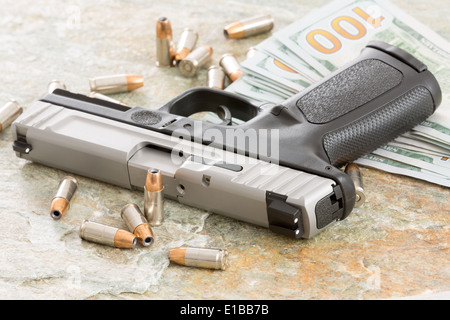 Wad of 100 dollar bills with a gun and bullets lying on a grunge wooden surface conceptual of a payoff, robbery, mercenary for h Stock Photo