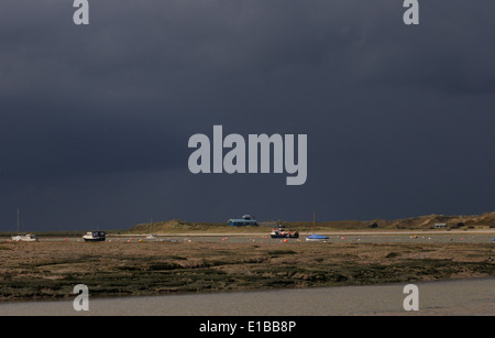 The Old Lifeboat House station and sand dunes on Blakeney Point against a dark sky. Blakeney, Norfolk. UK Stock Photo