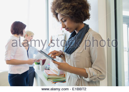 Businesswoman with digital tablet working in office