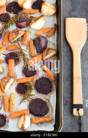 Beets, carrots, potatoes and purple onions roasted with rosemary Stock Photo